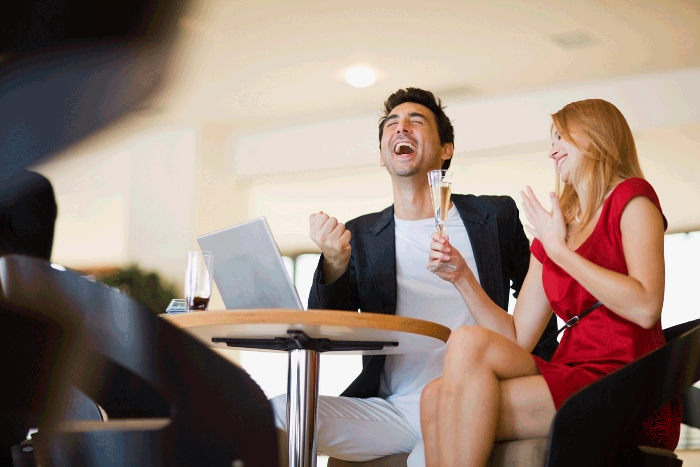 Couple celebrating after their realtor helped them buy their dream home